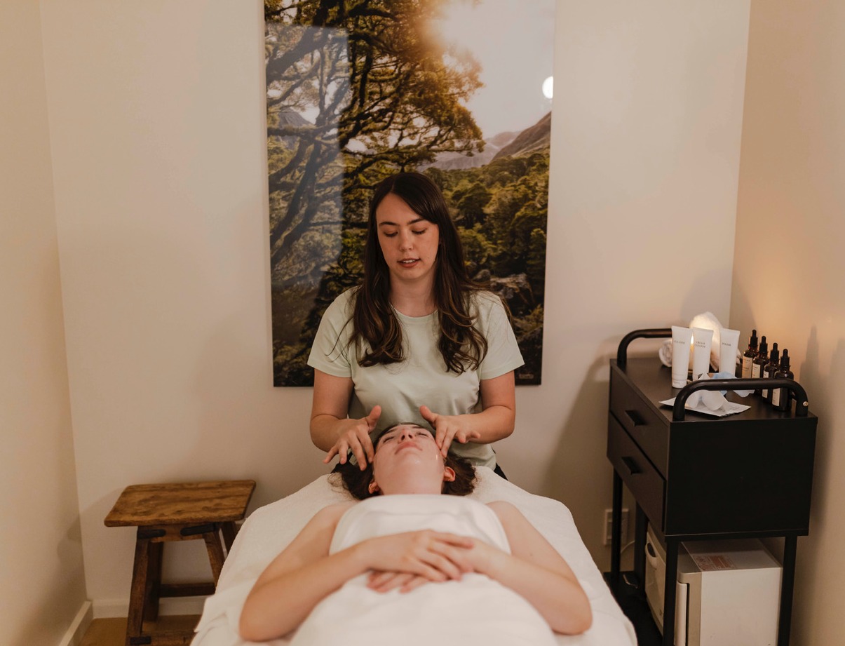 Beauty Therapist doing a facial massage at The Well Spa.