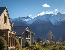 The Headwaters Eco Lodge with snowcapped mountains in the background
