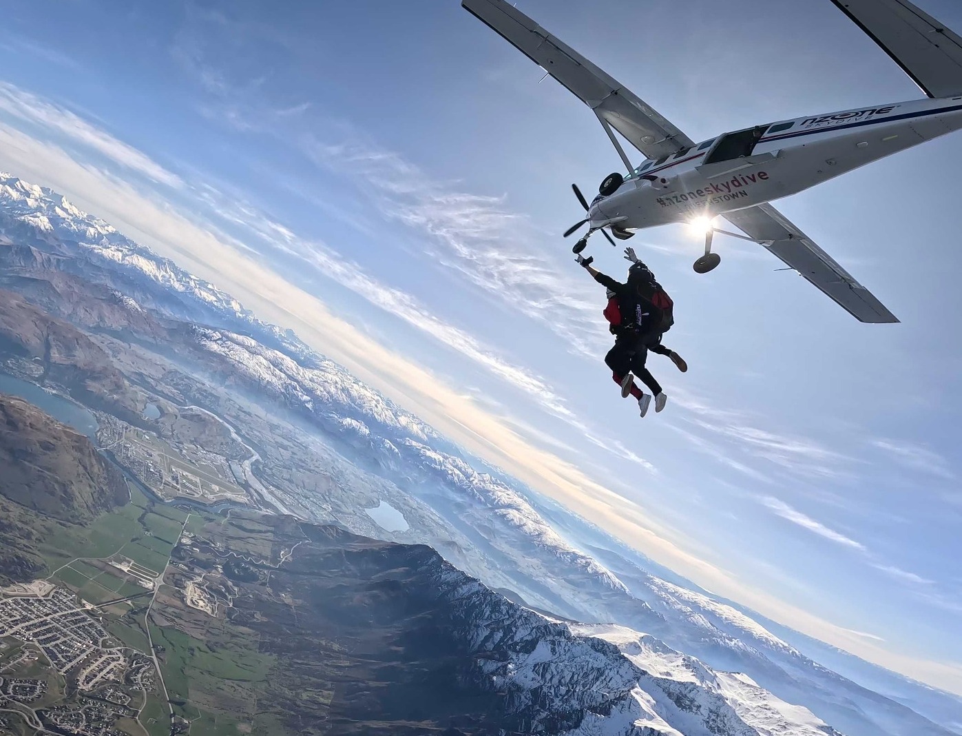 NZONE tandem skydiving having just exited the plane. Views of Queenstown beneath.