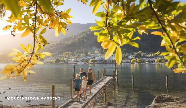 A family walk along a pier at the Queenstown Gardens