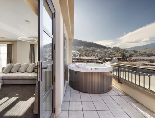 Sofitel Queenstown room with balcony and spa, with view over Queenstown CBD.